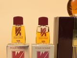 three bottles of perfume sitting next to each other on a table