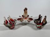 three glass birds sitting on top of each other on a white surface