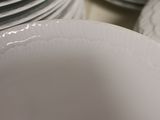 many white plates stacked on top of each other