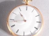a gold pocket watch hanging from a rope