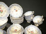 a lot of plates and cups that are sitting on a table