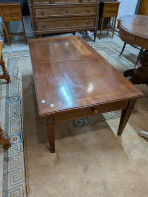 a table and chairs in a room with a rug on the floor