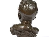 an antique bronze bust of a boy on a marble base