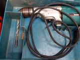 a blue box with a drill and a cord in it