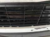 a dirty grille on the front of a white truck
