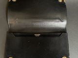 a black leather wallet sitting on top of a table