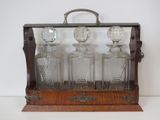 four glass decanters in a wooden case