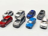 several toy cars are lined up in a row on a white surface