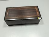 a small wooden box with a black and brown design