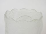 a white glass vase with a wave pattern on it