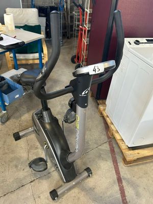 an image of a stationary exercise bike in a garage with a washing machine