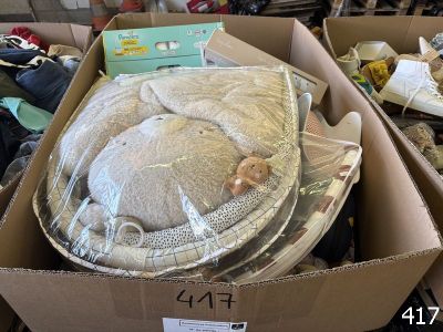a cardboard box with a stuffed animal inside of it