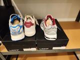 three pairs of shoes sitting on top of a black box