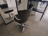 a chair that is sitting in front of a mirror