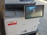 une imprimante posée sur une étagère près d'une fenêtre