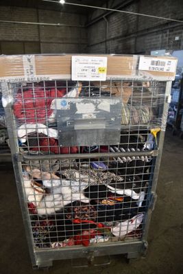 a metal cage filled with many pairs of shoes