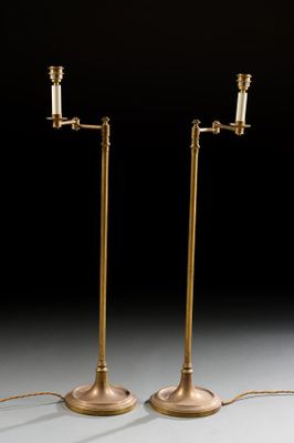 a pair of brass plated floor lamps