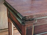 a small wooden table with a drawer on top of it