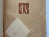 an open book with a picture of a diamond and a logo on it