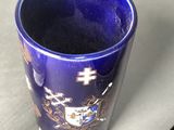 a blue cup sitting next to a plate on a table