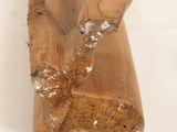 a piece of wood that is sitting on a white surface