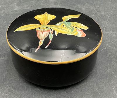 a black box with a yellow flower painted on it