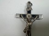 a silver crucif with a bird perched on top of it
