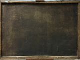 an old blackboard with a wooden frame hanging on a wall