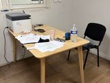 a desk with a printer and a chair in a room