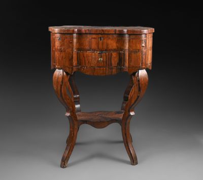 a small wooden table with a drawer on top of it
