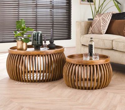 two tables that are sitting on the floor in the living room