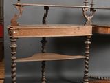 a desk with a shelf and a chair in front of a gray wall