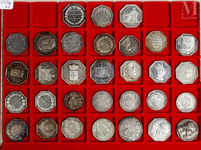 a lot of silver coins in a red display case