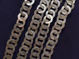 a close up of a metal chain on a black surface