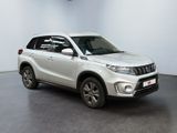 the white suzuki vitax is parked in a large room