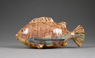 a small ceramic fish that is sitting on a table