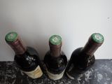 three bottles of wine sitting next to each other on a table