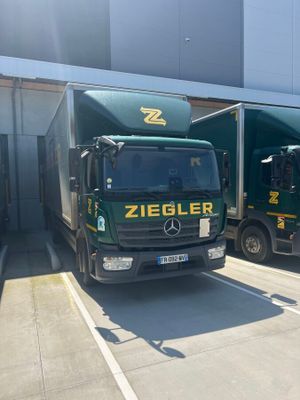two trucks that are parked next to each other in a parking lot