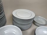 a lot of plates and bowls stacked on top of each other
