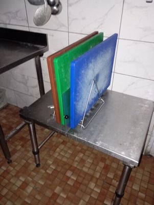 a metal table with a bunch of cutting boards on top of it