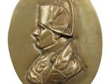 an image of a gold medal with a man in a hat