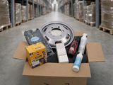 a box of assorted items sitting on a floor in a warehouse