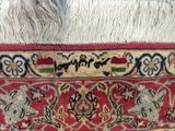 a close up of a rug with a horse on it ' s back