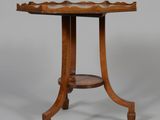 an old wooden table with a curved top and a curved base