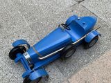a blue toy car that is sitting on the ground