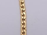 a yellow gold bracelet with a heart shaped link