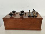 a wooden box with four different types of electrical equipment on it
