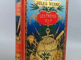 un vieux livre rouge avec une couverture dorée sur laquelle figure une horloge