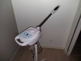 a white and black steam mop sitting on top of a wooden floor