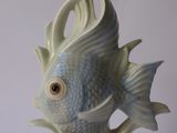 a white and blue fish figurine on a white table